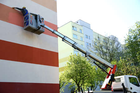 Painting the facade from a height using a special jib.