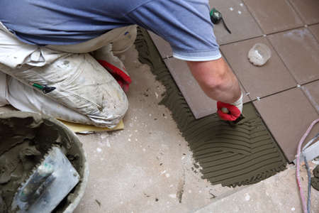 The construction worker even spreads with adhesive tape.