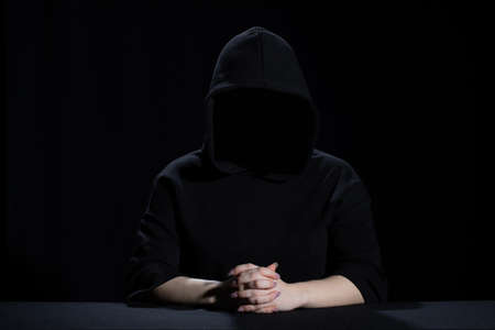 A teenager wearing a black hoodie is waiting for new events.の写真素材