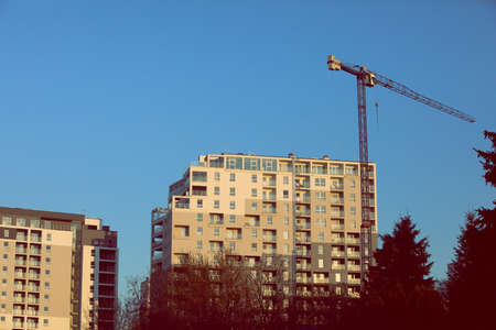 A modern building in the middle of a housing estate for many families or offices.