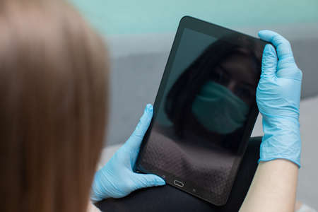 if the tablet is used by more people, for safety you have to put on rubber protective gloves so as not to get infected.の写真素材