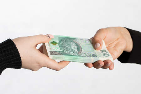 On the zoom you can see female hands full of banknotes as they exchange cash.の写真素材