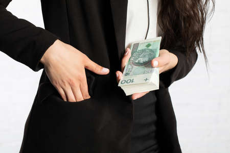 Close-up shot of banknotes and a woman's hand.の写真素材