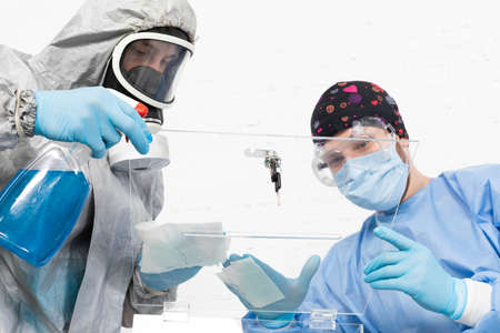 Two men clean and disinfect the polling place just before the start of the presidential election in Poland.の写真素材