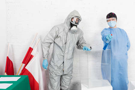 Two men clean and disinfect the polling place just before the start of the presidential election in Poland.の写真素材
