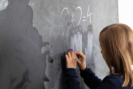 One girl from the class was appointed to wipe the wet sponge of the school board.の写真素材