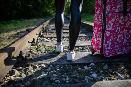 Railway tracks in the middle of a deciduous forest. A hot summer day. A holiday adventure awaits everyone who travels every day.の写真素材