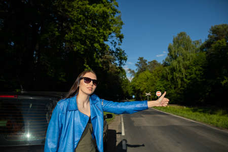 Young adult shapely girl. The girl is standing on the side of a poultry running through the forest....