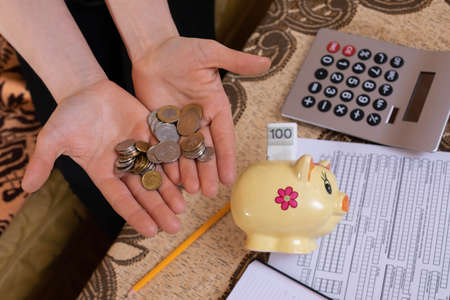 The first money saved, even the smallest ones, gives reason to be happy and proud. A young adult successfully saves and invests the earned money.の写真素材