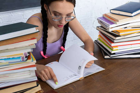 The girl studies the calendar diligently to check the dates of the next exams and plan her time well.の写真素材