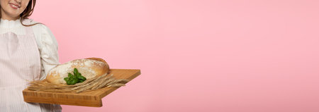 Panoramic frame. A young girl of beautiful European beauty holds in her hands on a wooden board a...