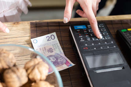 The sellers responsibility is also to punch all transactions concluded in the bakery shop with the cash register. A multi-generation baking tradition.の写真素材