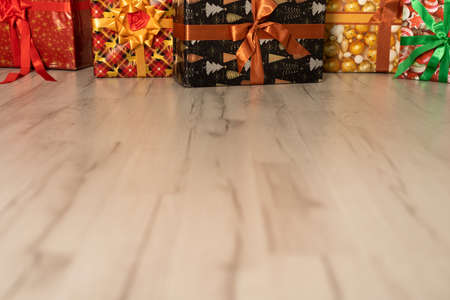 Decoratively wrapped gifts for guests for Christmas lie on the floor.の写真素材