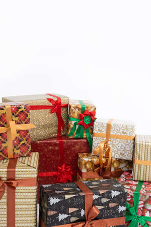 On a plain white background, there are colorful gift packages tied with a bow. Christmas holidays.