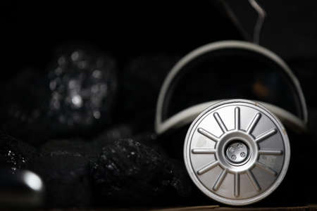 Dust mask with filter lies on black coal background for mine rescuers