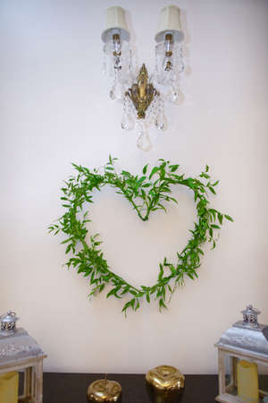Decorating the venue during the reception by arranging a heart symbol from a ruscus plant.の写真素材
