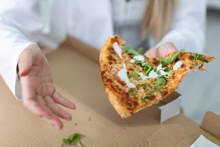 In between on-call duties, doctors eat pizza.の写真素材