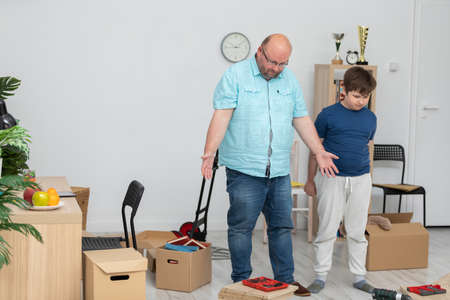 A father and son set about assembling a bookcase.の写真素材