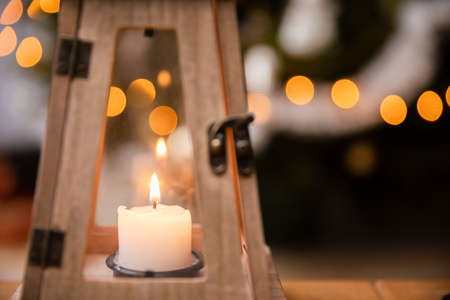 A candle burns closed inside a decorative lantern on Christmas Day.の写真素材