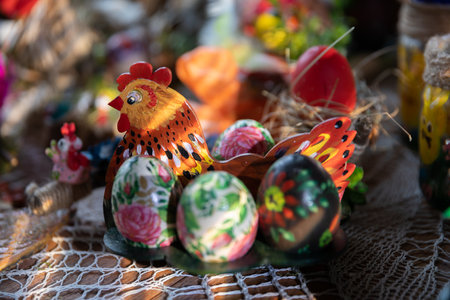 A hen shape artistically painted in color. Several Easter eggs.の写真素材