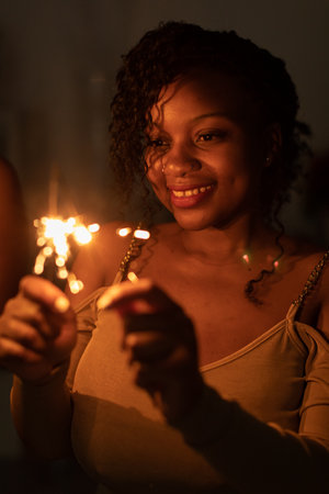 The dark-skinned girl holds a burning cold fire in her hand.の写真素材