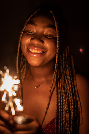 The joy of an African woman during the burning of cold fires. New Year.の写真素材