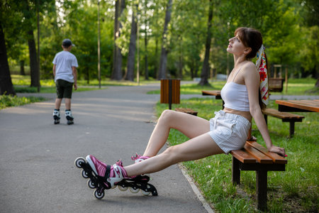 Girls and on roller skates relaxes after a practice.の写真素材