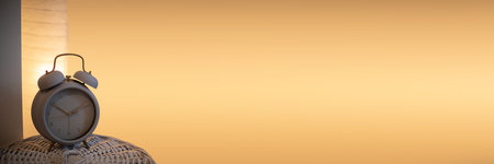 Panoramic frame for evening bedroom decor with bedside lamp and analog alarm clock.の写真素材