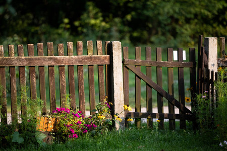 Wooden old fence, composed of many rails in the sunshine.