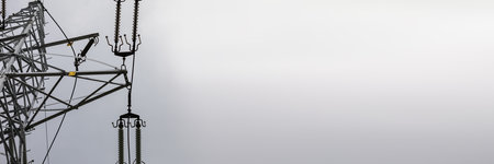 A fragment of a high voltage line in a panoramic view in a cloudy sky.