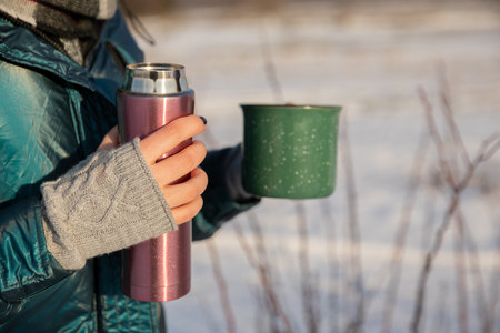 Morning coffee drunk outdoors on a winter day.の写真素材