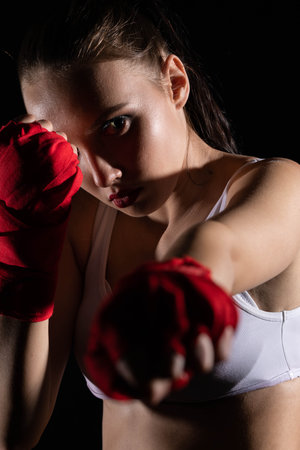 The athlete hits the fist straight ahead. Technical training before the fight in the ring.の写真素材