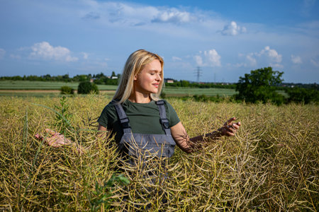 A Young Woman Happily Enjoying the Beautiful Nature in a Field Beneath a Clear Blue Sky