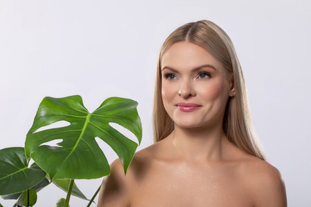 An Elegant and Stunning Portrait Featuring a Monstera Plant Accented with a Glitter Effectの写真素材