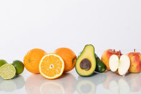 Explore a Beautiful Selection of Fresh Seasonal Fruits Citrus, Avocado, and Appleの写真素材