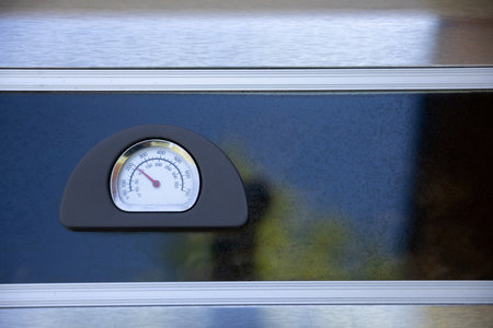 A Detailed and CloseUp View of a Thermometer Positioned on the Surface of a Grill