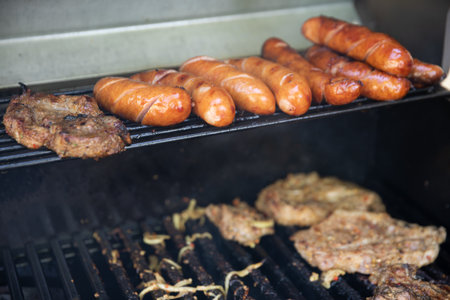 Delicious Savory Grilling Enjoying Sausages and Meat Cooked Perfectly on the BBQの写真素材