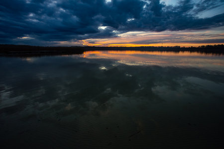 Experience the breathtaking serene sunset reflections over the tranquil waters at dusk