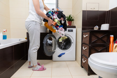 Laundry Day A Simple Yet Significant Moment of Routine in a Contemporary Bathroom Spaceの写真素材