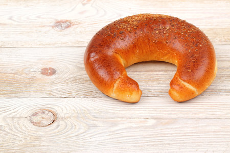 A Freshly Baked, Deliciously Traditional Bread Roll Placed Beautifully on a Wooden Surface