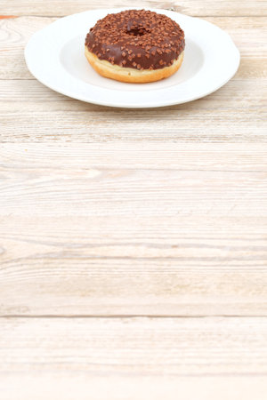 The Chocolate Donut placed on a pristine White Plate A Truly Sweet Dessert Delight to Enjoyの写真素材