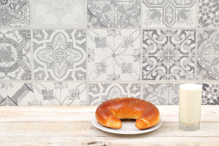 An Irresistibly Delicious Bagel Paired with Fresh Milk on a Charming Rustic Table Background