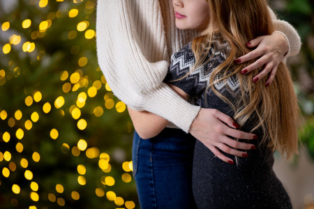 A Warm Embrace Shared Amidst the Twinkling Holiday Lights During the Festive Seasonの写真素材
