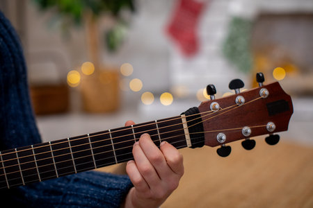 Enjoy a Cozy Indoor Guitar Playing Session Enhanced with Soft, Warm Lights and Ambiance