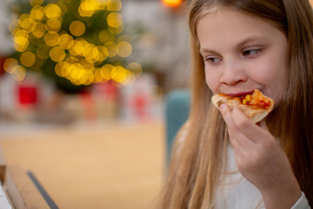 A joyful girl relishing a delicious slice of pizza in a colorful and festive atmosphere