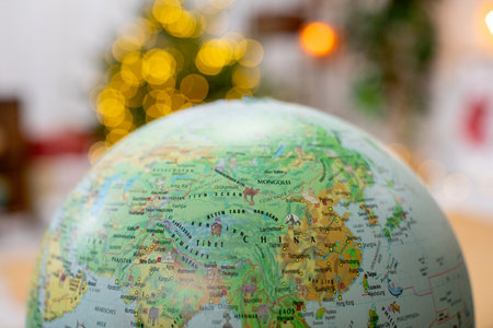 A beautifully arranged globe sits on the table, surrounded by a delightful holiday ambianceの写真素材