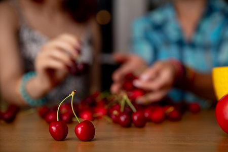 Enjoying the delightful activity of cherry picking together with good friends in a cozy settingの写真素材