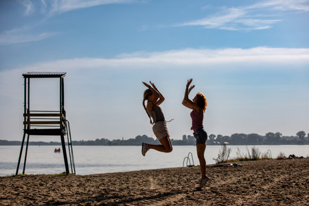 Joyful and carefree children happily playing at the beautiful beach on a sunny day