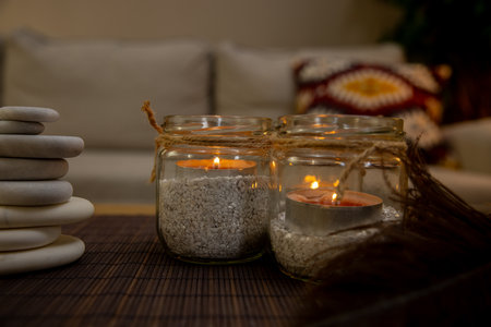 Experience the Cozy Candlelight Decor featuring Elegant Jars that create a Relaxing Atmosphereの写真素材