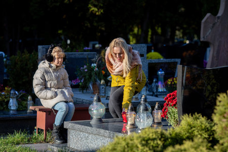 Visiting Our Beloved Loved Ones A Cherished Moment of Remembrance in a Peaceful Cemeteryの写真素材